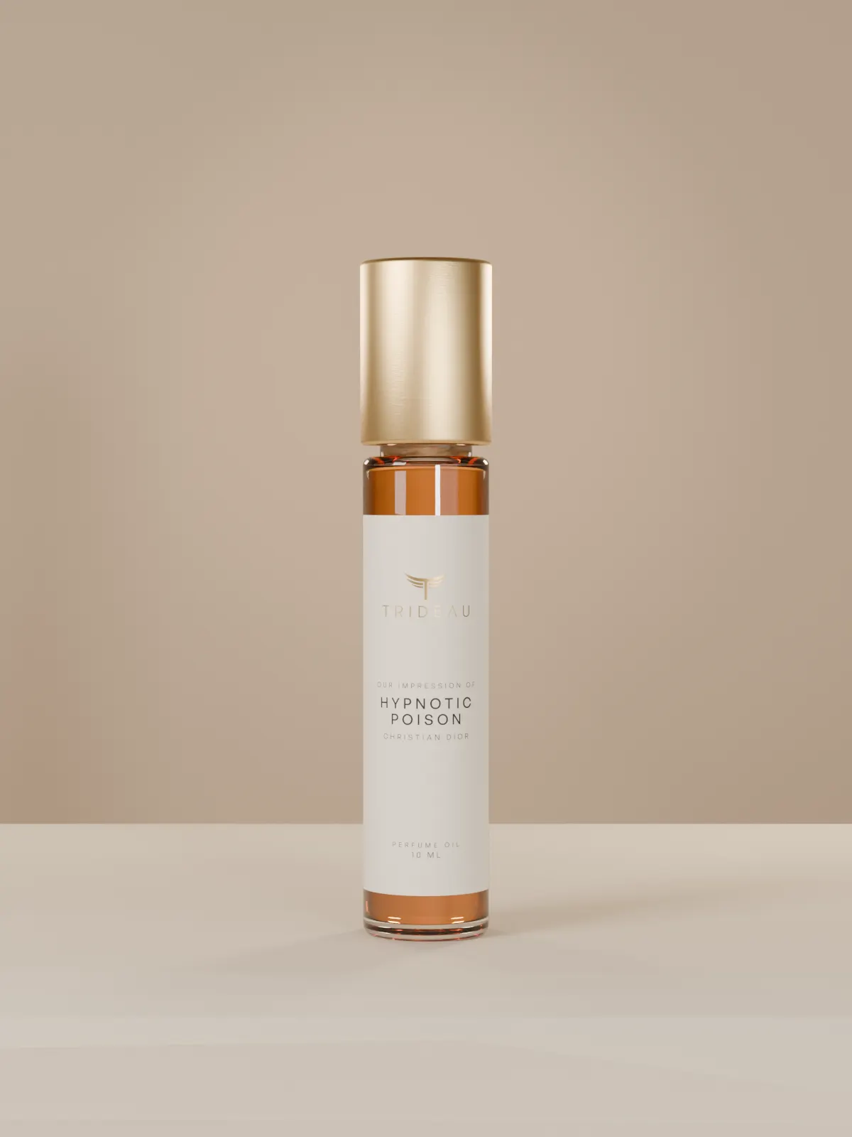 A Trideau 10 ml rollerball with a matte gold cap and a cream label